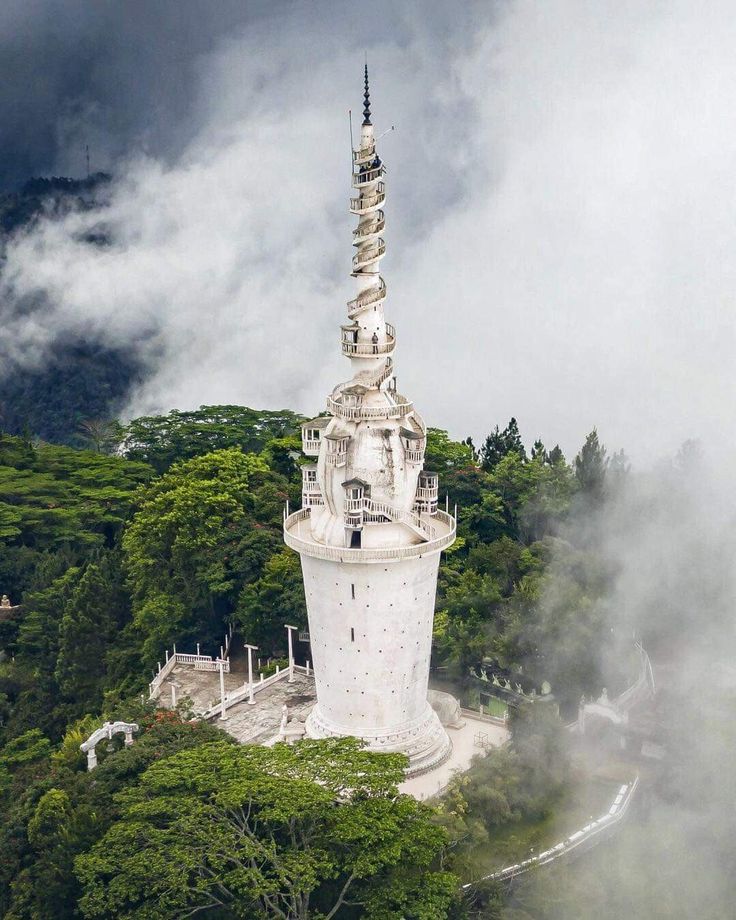 Ambuluwawa white tower rising above misty green hills in Sri Lanka